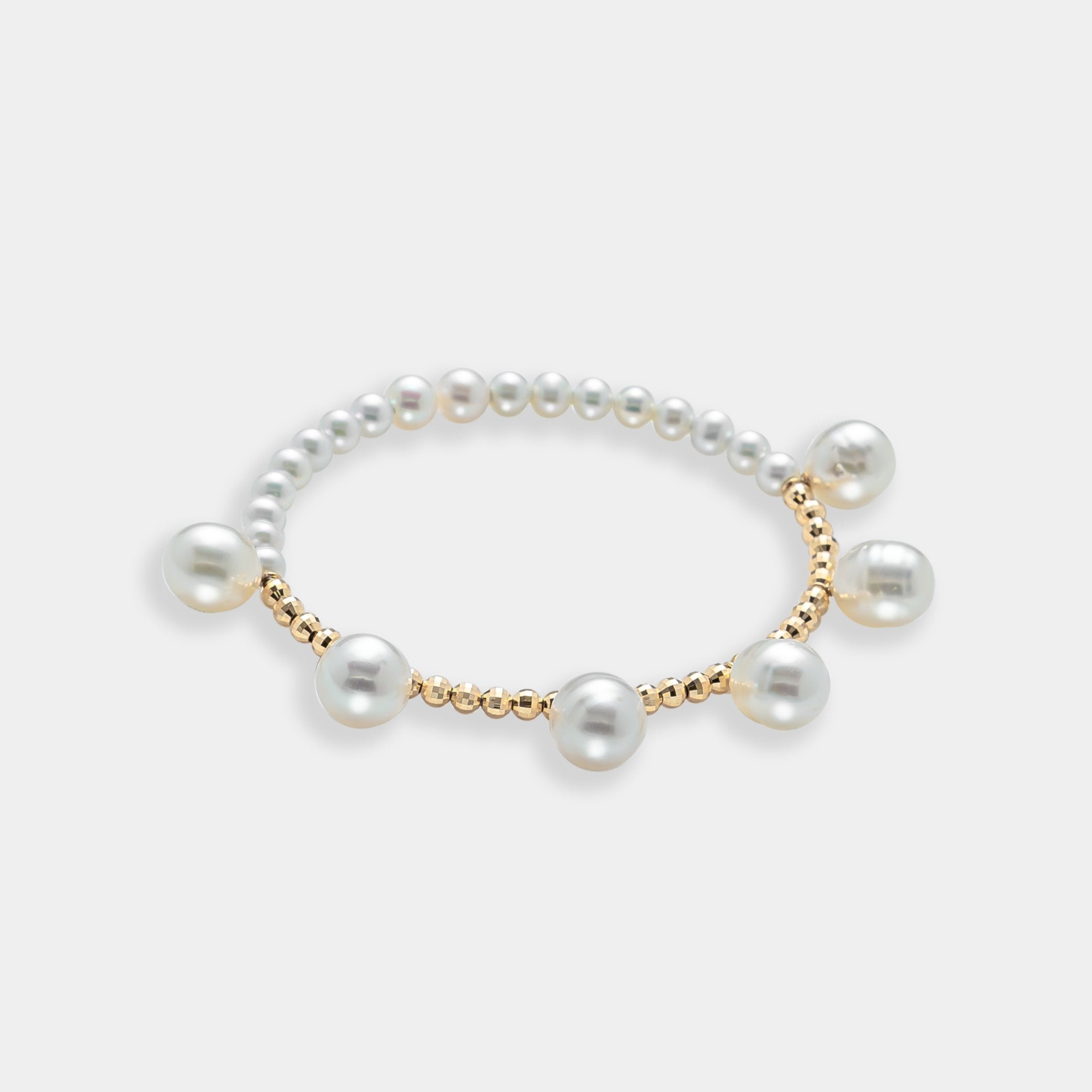 Elegant pearl bracelet with gold beads on a white background. Perfect for adding a touch of sophistication to any outfit.