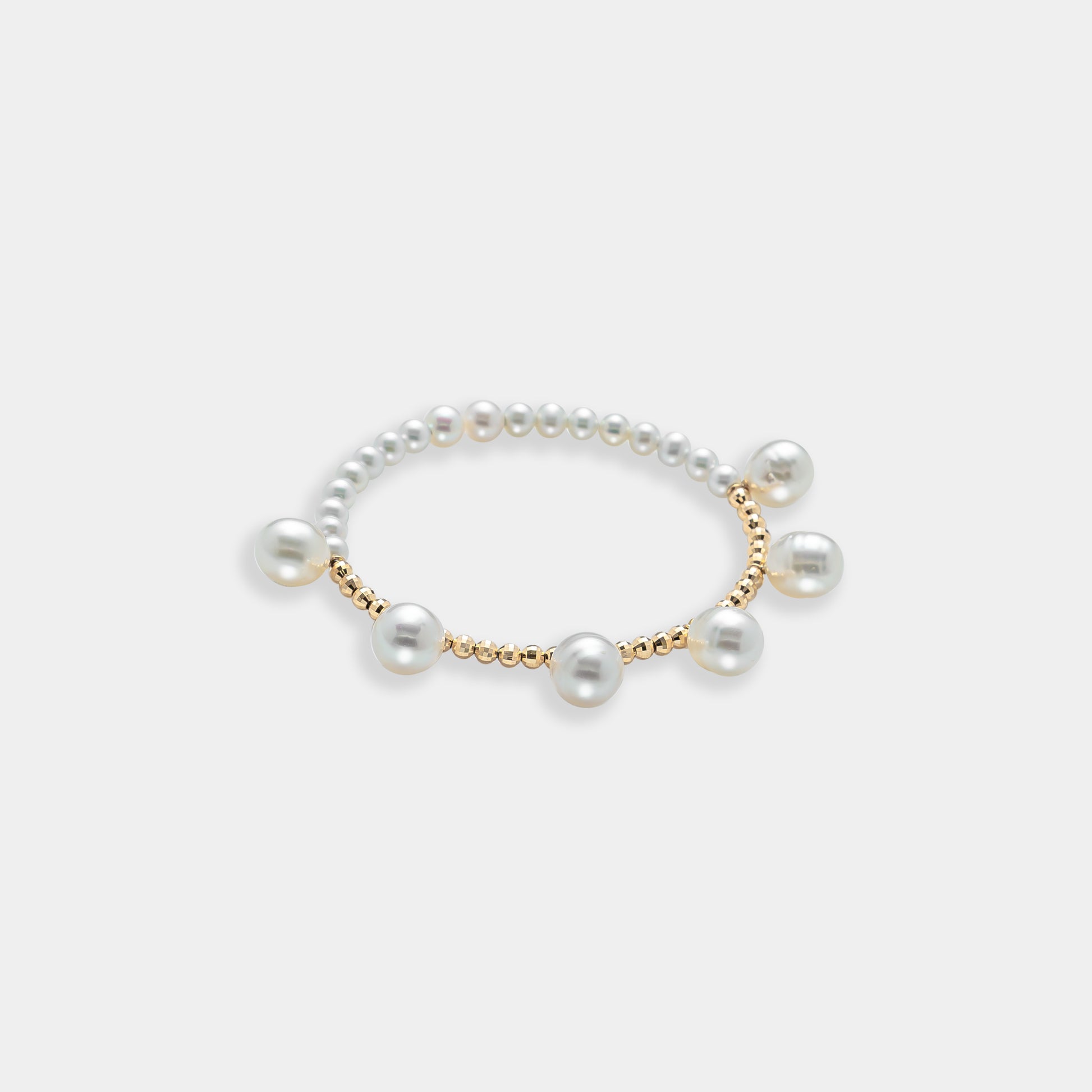 Elegant pearl bracelet with gold beads on a white background. Perfect for adding a touch of sophistication to any outfit.