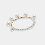 Elegant pearl bracelet with gold beads on a white background. Perfect for adding a touch of sophistication to any outfit.