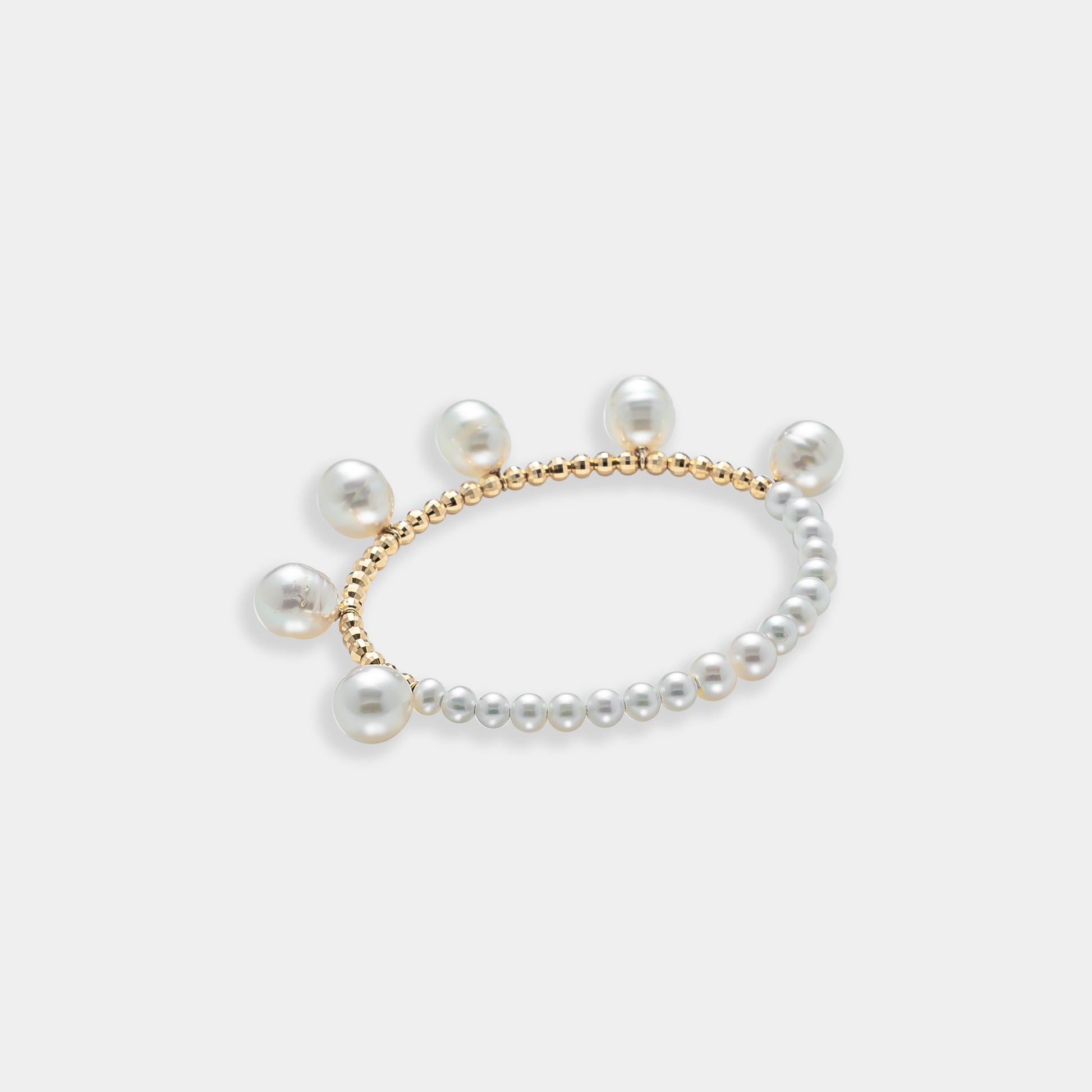 Elegant pearl bracelet with gold beads on a white background. Perfect for adding a touch of sophistication to any outfit.