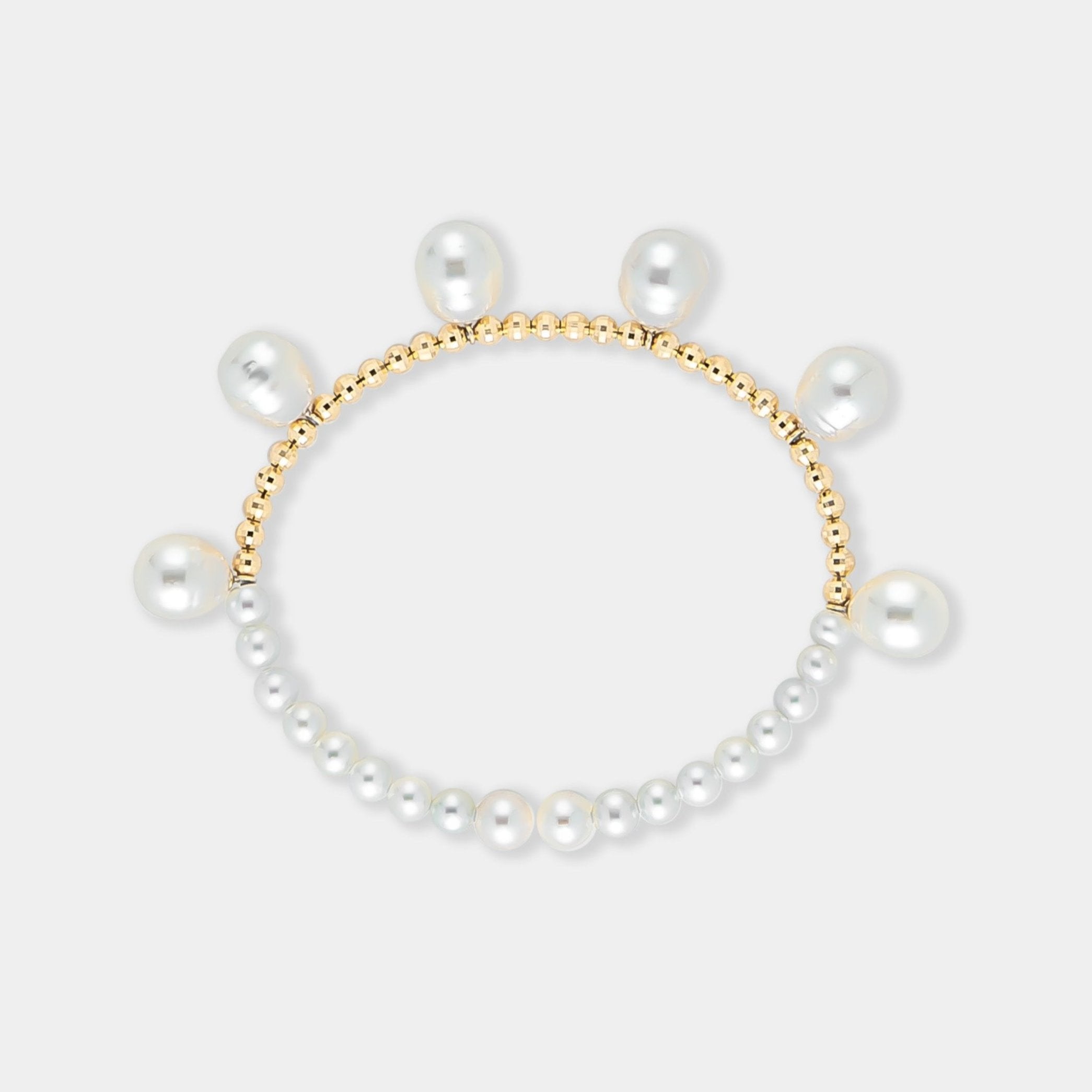 Elegant pearl bracelet with gold beads on a white background. Perfect for adding a touch of sophistication to any outfit.