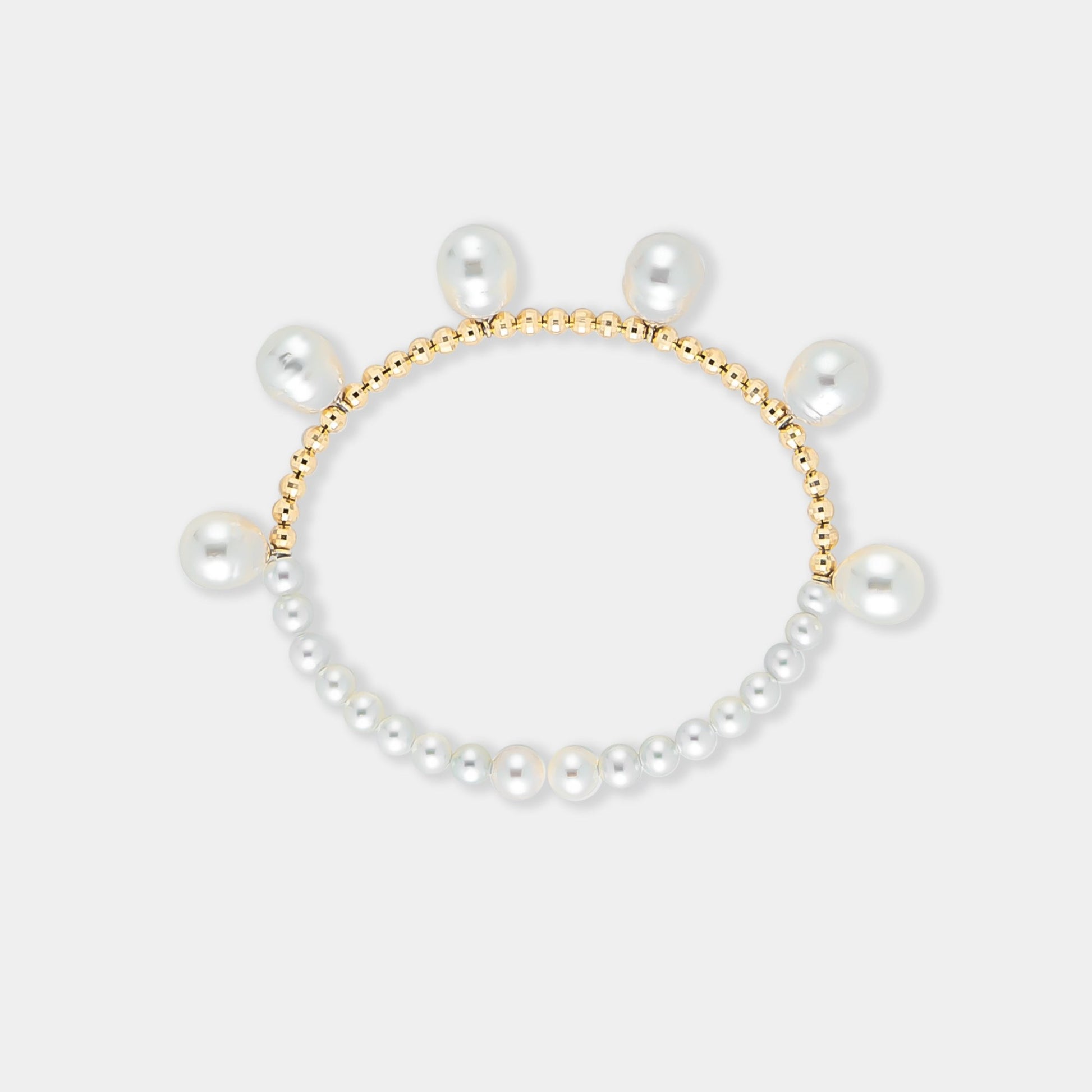 Elegant pearl bracelet with gold beads on a white background. Perfect for adding a touch of sophistication to any outfit.