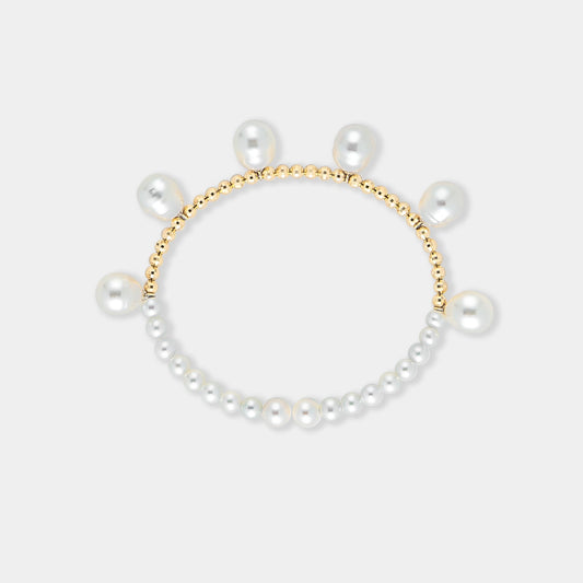 Elegant pearl bracelet with gold beads on a white background. Perfect for adding a touch of sophistication to any outfit.