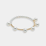 Elegant pearl bracelet with gold beads on a white background. Perfect for adding a touch of sophistication to any outfit.