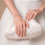 Enhance your elegance with a white dress and clutch bag, complemented by a stunning Pearl Dot x White Gold Bracelet.