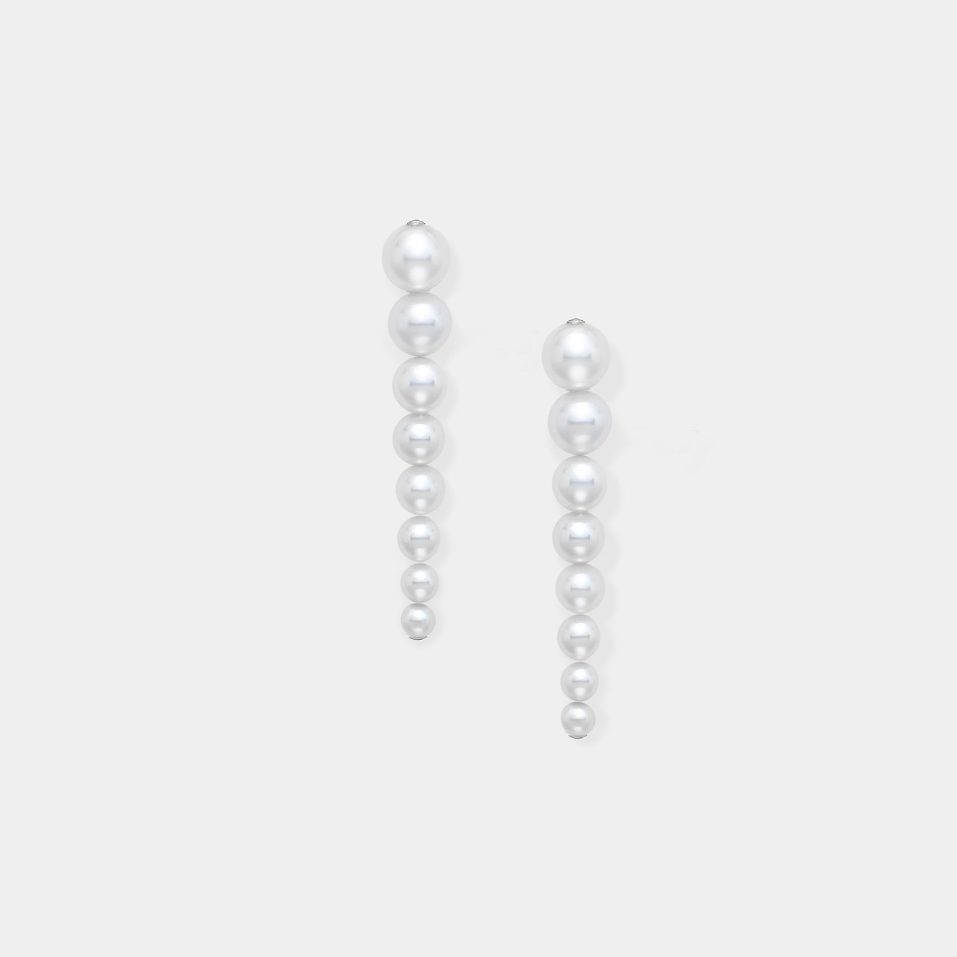 Enhance your elegance with Stella Piercing's exquisite pearl earrings on a pristine white background.