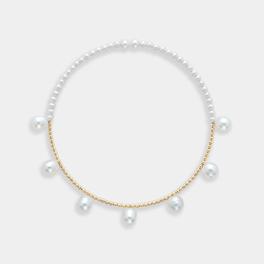 Enhance your elegance with a stunning Pearl Dot x Gold Choker, featuring a pearl necklace adorned with gold beads and pearls.