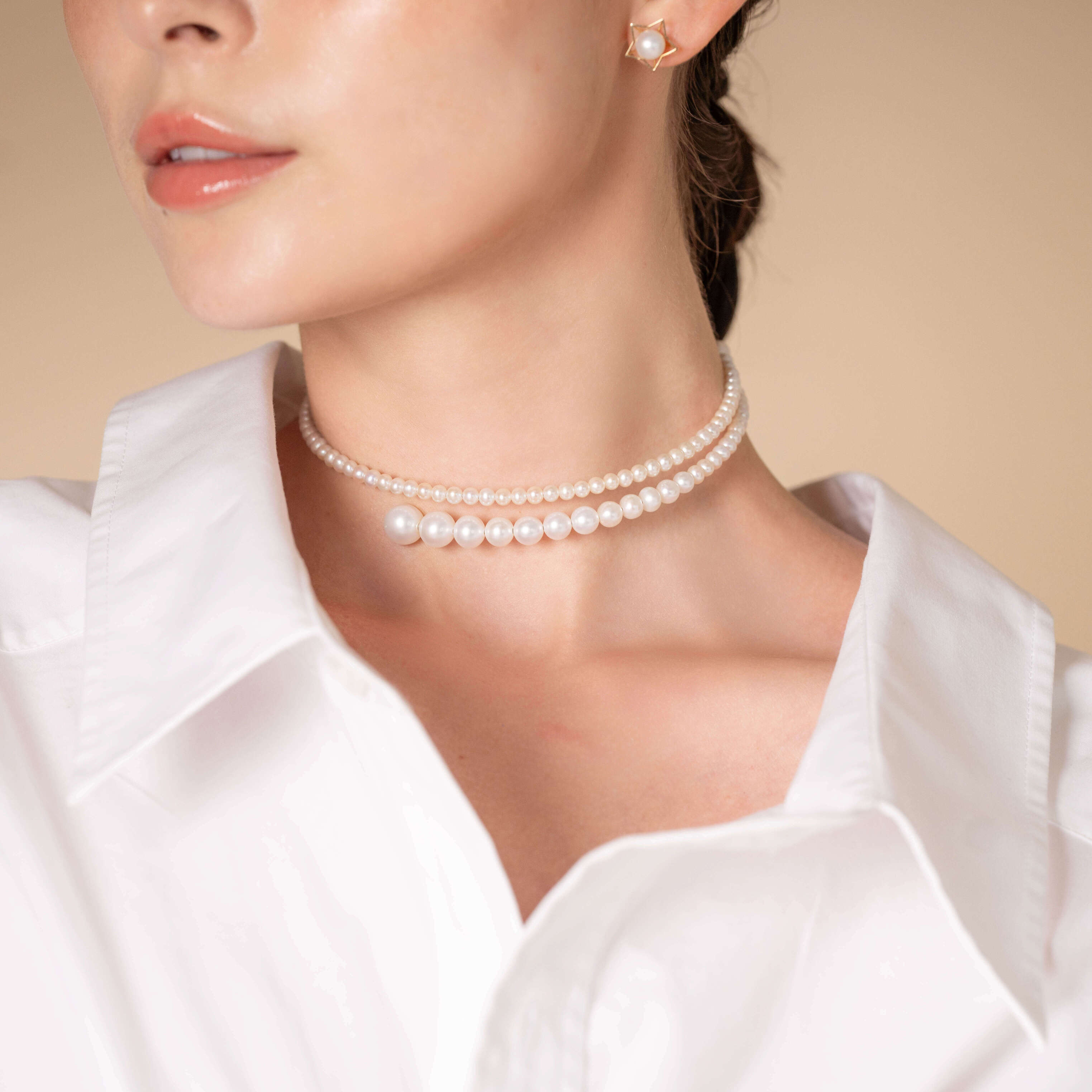 Chic woman wearing white shirt and stunning Spiral Pearl Choker.