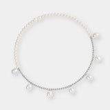 Luxurious pearl and white gold beads against a clean white backdrop, a stunning accessory for any occasion.