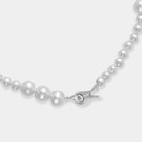 A luxurious long necklace adorned with lustrous freshwater pearls and a sleek silver clasp.