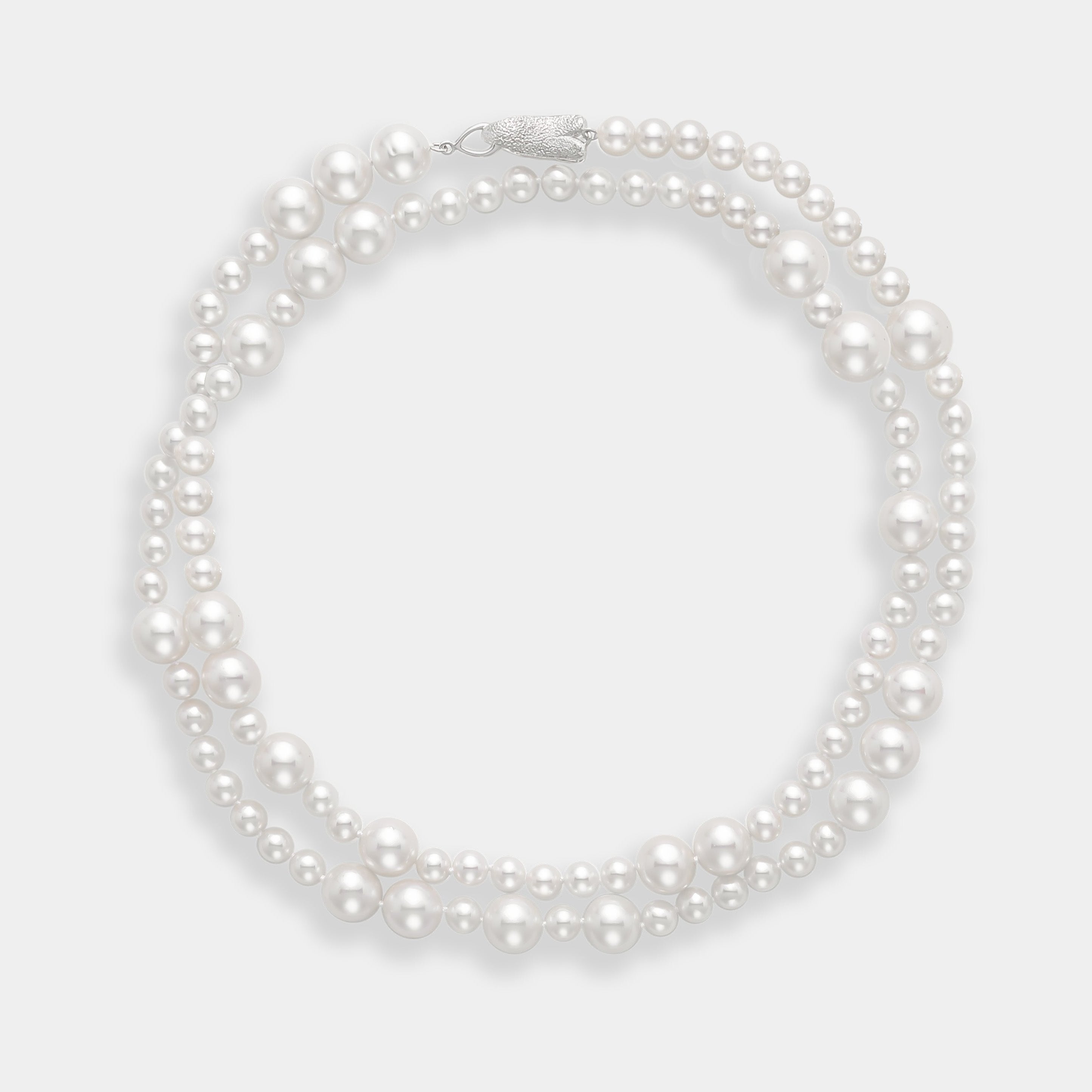 Elegant long freshwater pearl necklace with a silver clasp, a timeless accessory.