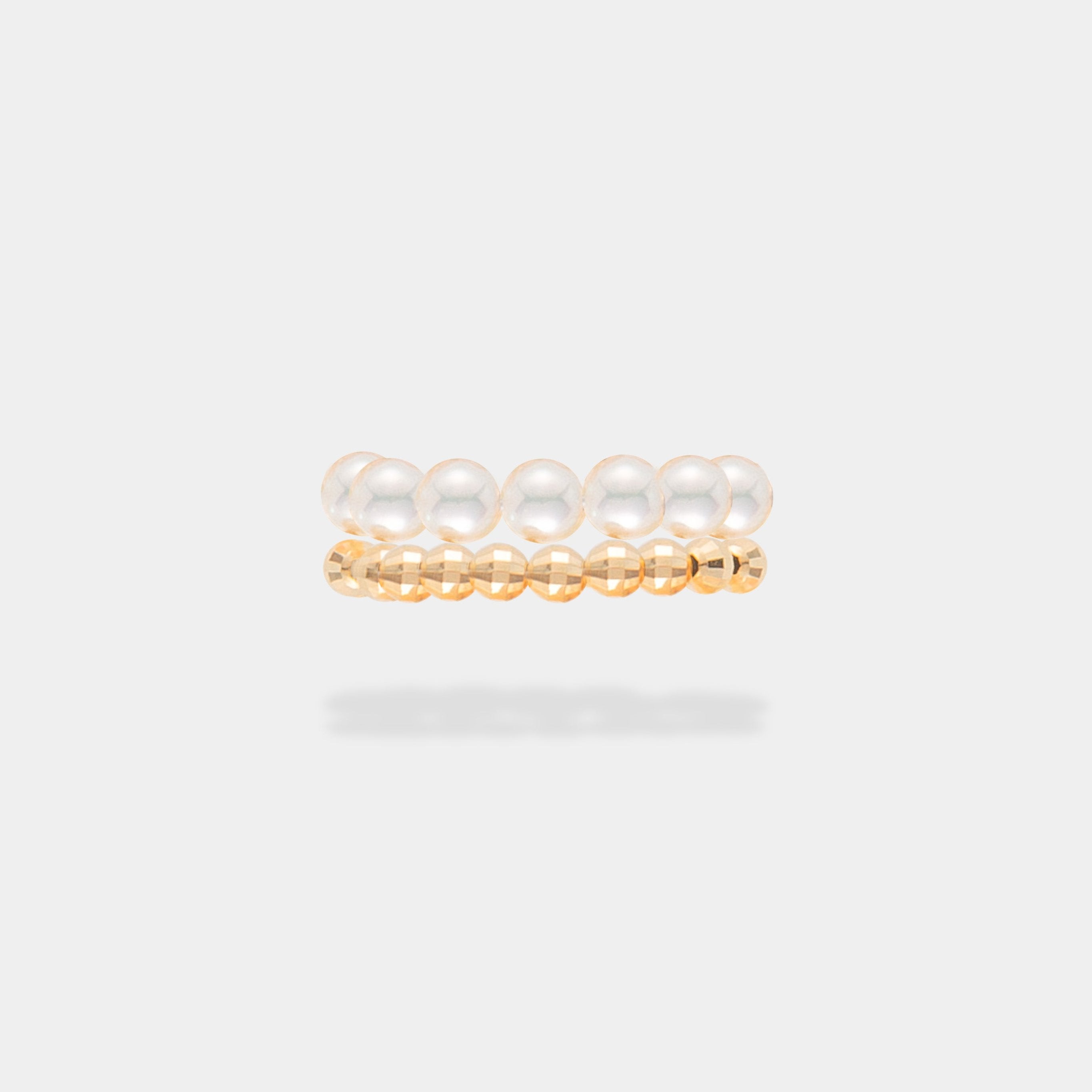 Elevate your style with the captivating Spiral Pearl x Gold Ring, gracefully showcased on a woman's hands.