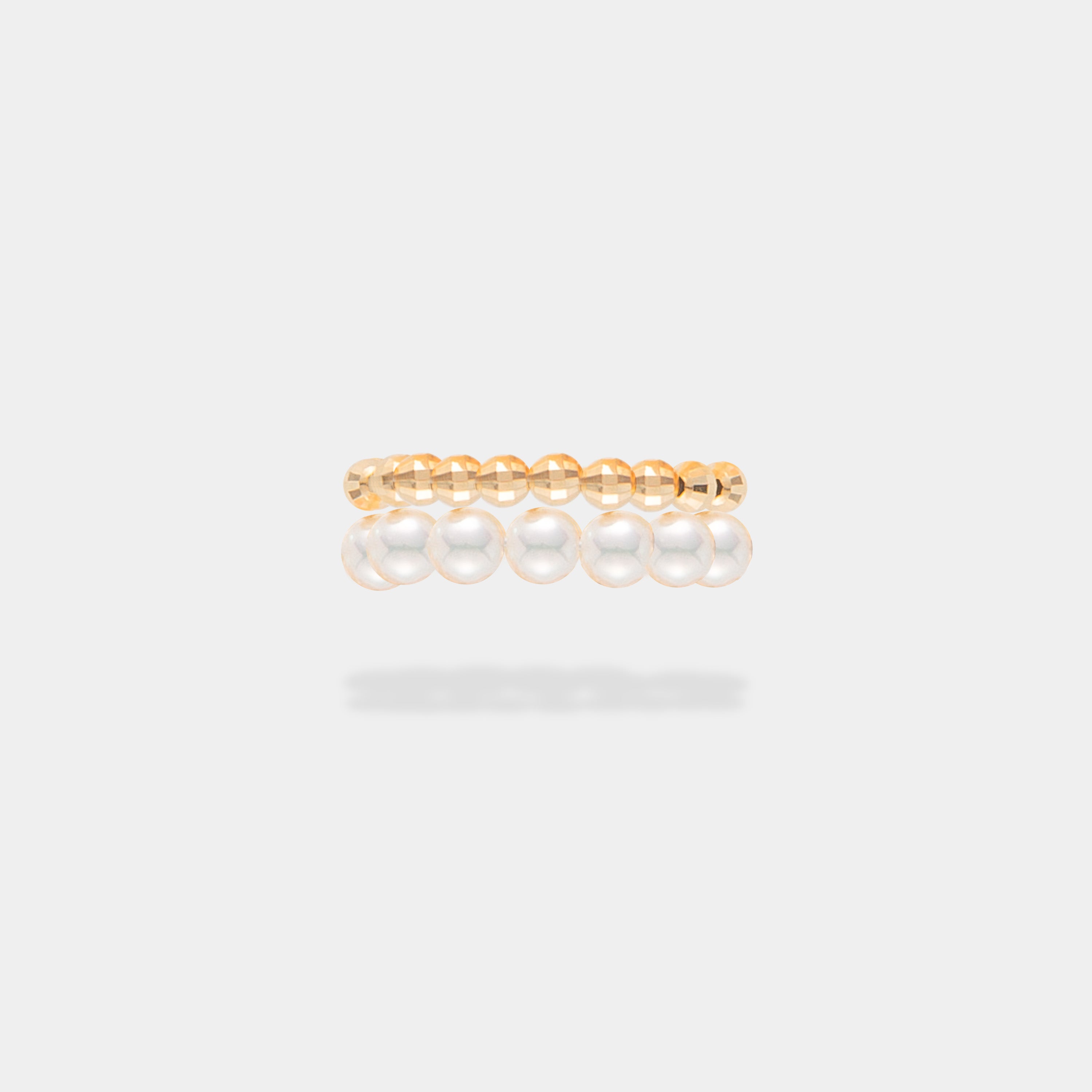 Elevate your style with the captivating Spiral Pearl x Gold Ring, gracefully showcased on a woman's hands.