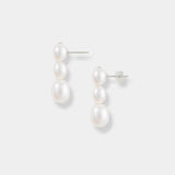 Experience sophistication with these elegant pearl drop earrings showcased on a pure white background. A touch of luxury.