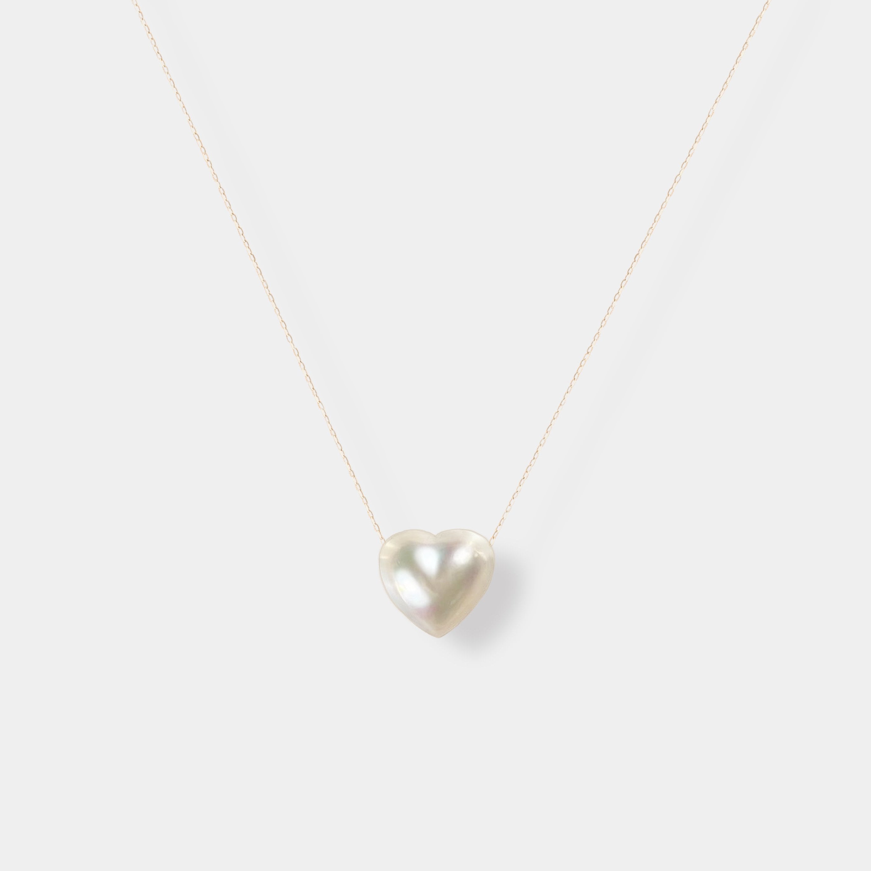 Enhance your elegance with our exquisite Heart Pearl Chain Necklace - a stunning white pearl heart pendant on a delicate gold chain.