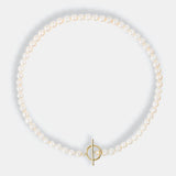 A Mantel Pearl Necklace Short with a gold clasp and a dainty pearl, elegantly adorning a pearl bracelet.